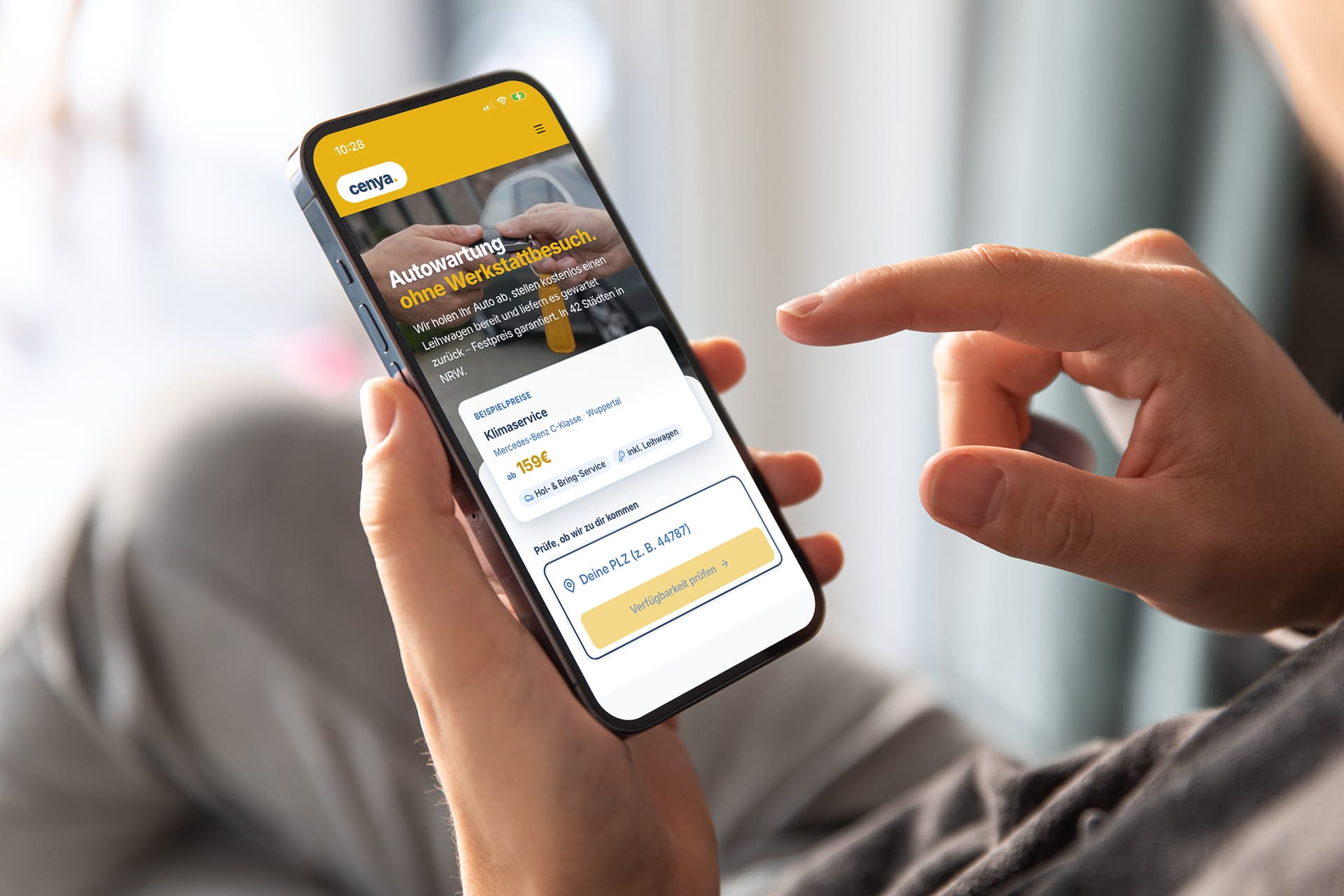 Hand holding smartphone — booking the cenya. service online
