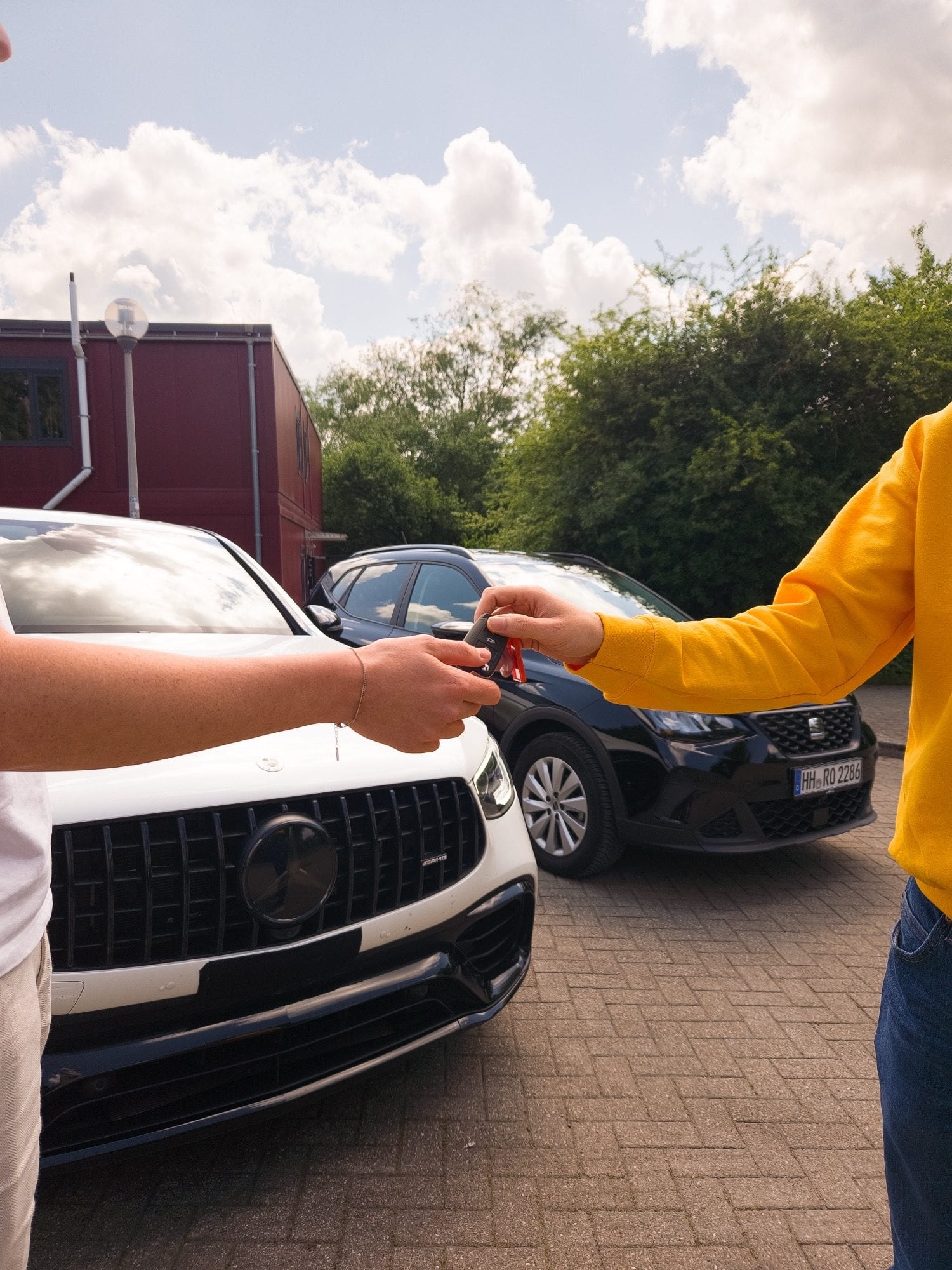 cenya. driver in yellow pullover handing over the key on return